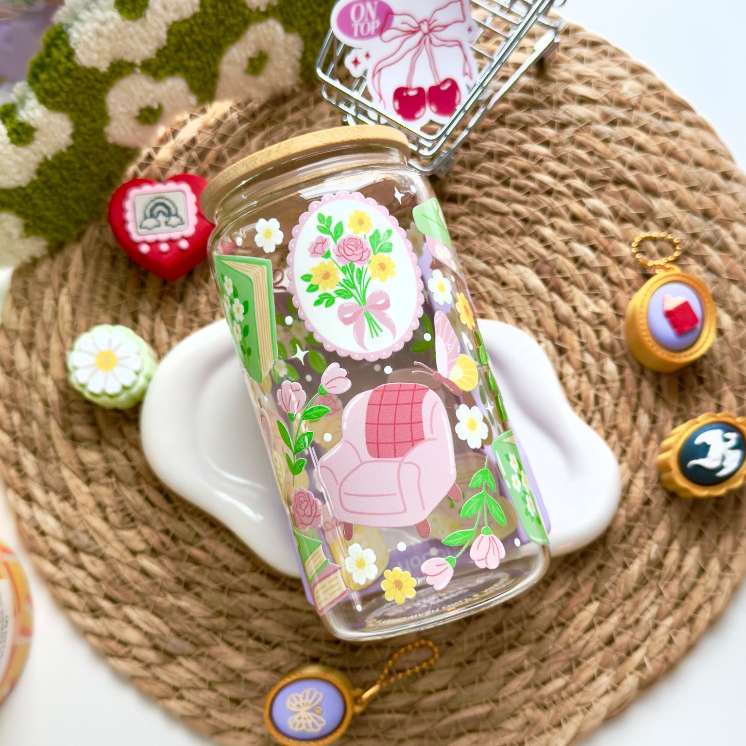 Decorative glass bottle with floral design on a woven mat